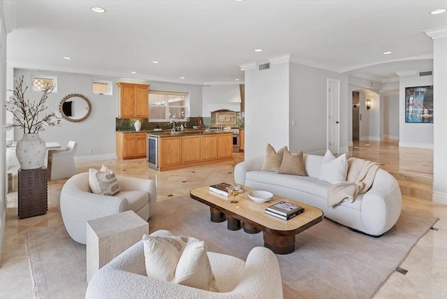 living room featuring wine cooler, crown molding, recessed lighting, visible vents, and baseboards