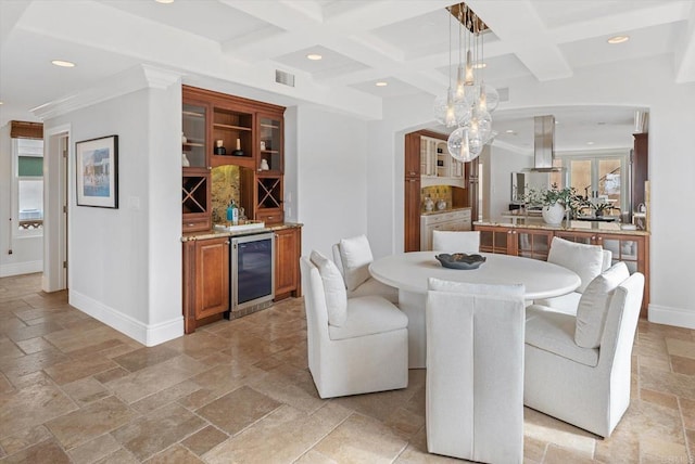 dining space with beverage cooler, visible vents, stone tile floors, and recessed lighting