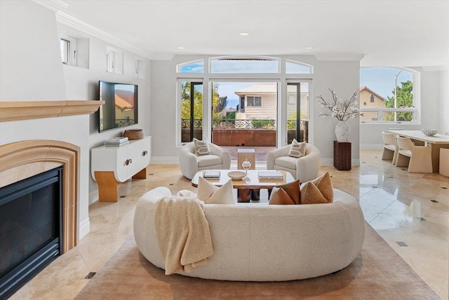 living area featuring recessed lighting, baseboards, ornamental molding, and a glass covered fireplace