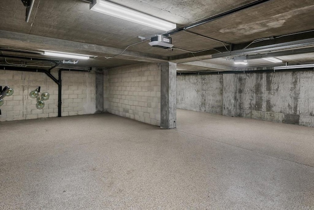 parking garage with a garage door opener and concrete block wall