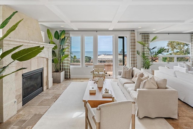 sunroom featuring plenty of natural light, beam ceiling, coffered ceiling, and a tiled fireplace