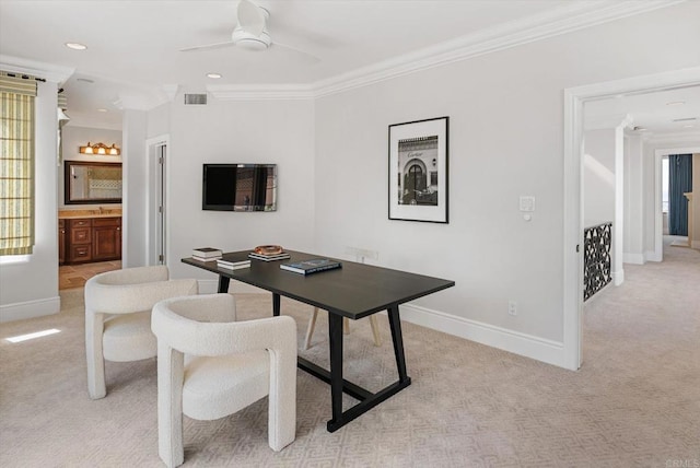 office with light colored carpet, visible vents, ornamental molding, a ceiling fan, and baseboards