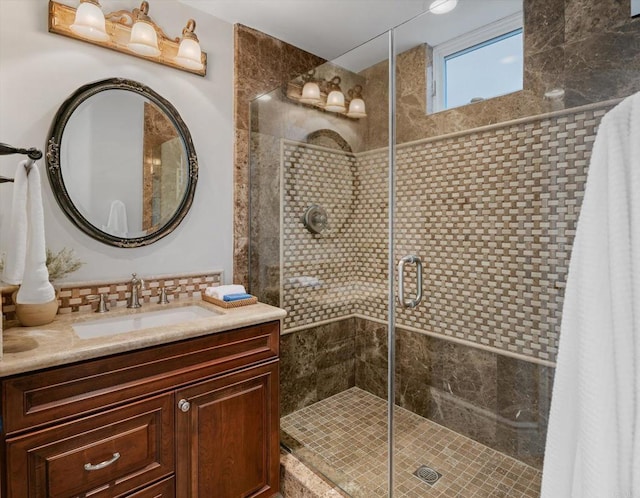 full bath featuring tasteful backsplash, a shower stall, and vanity