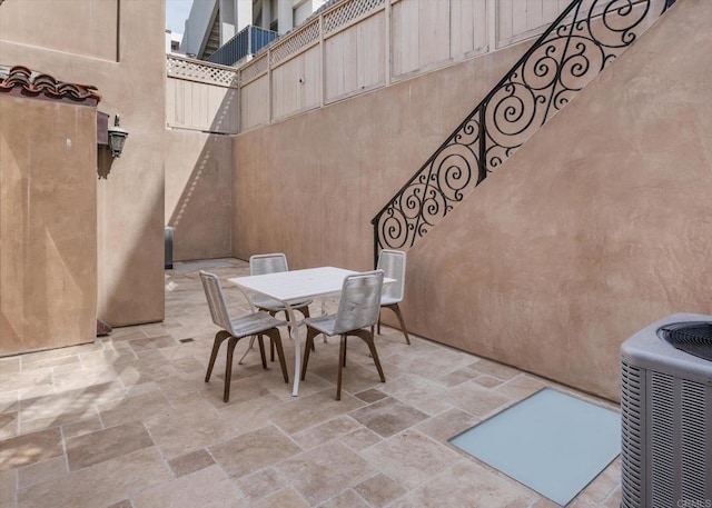 view of patio with central AC unit and outdoor dining area