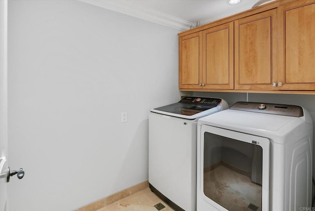 washroom with cabinet space, baseboards, crown molding, and independent washer and dryer