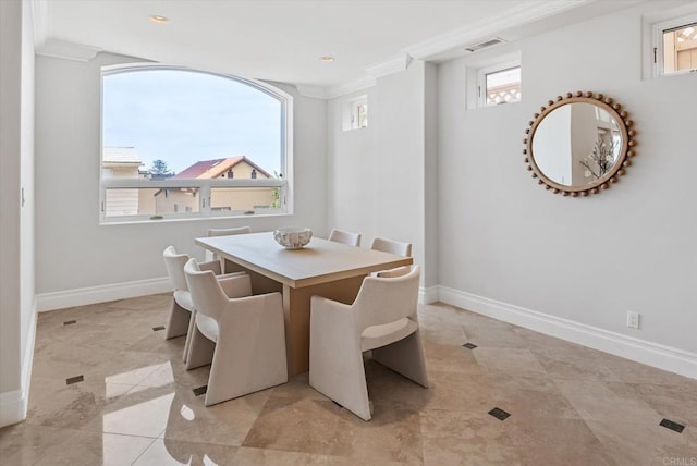 dining space with baseboards, visible vents, and ornamental molding