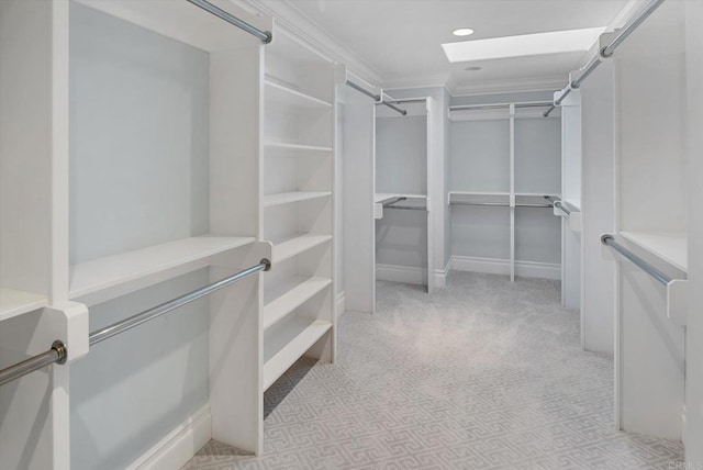 walk in closet featuring light carpet