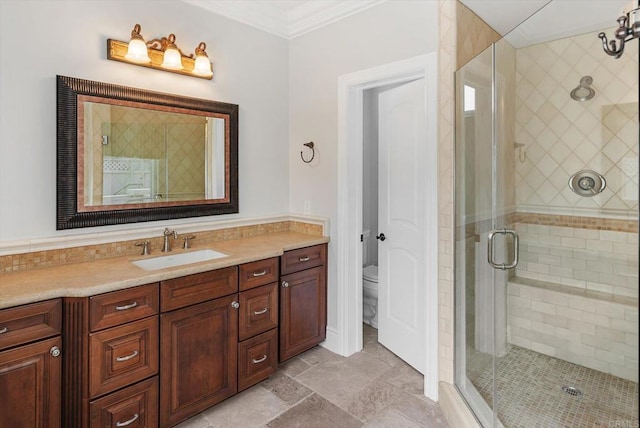 full bath with ornamental molding, a shower stall, toilet, and vanity