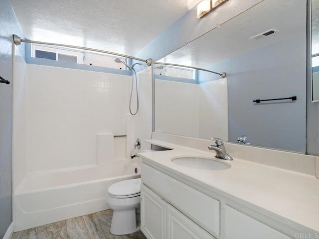 full bathroom featuring visible vents, toilet, shower / tub combination, a textured ceiling, and vanity