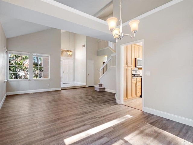 interior space with a notable chandelier, stairway, wood finished floors, high vaulted ceiling, and baseboards