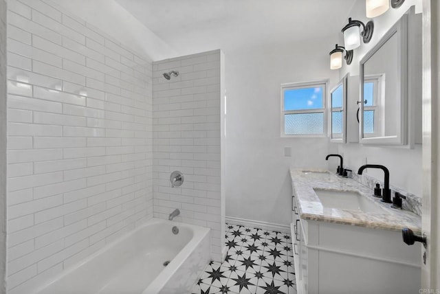 full bathroom with double vanity, baseboards, a sink, and shower / bathing tub combination