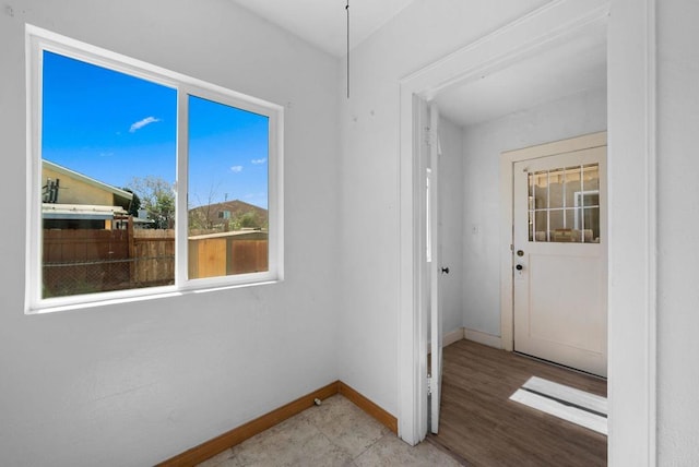 interior space with light wood finished floors and baseboards