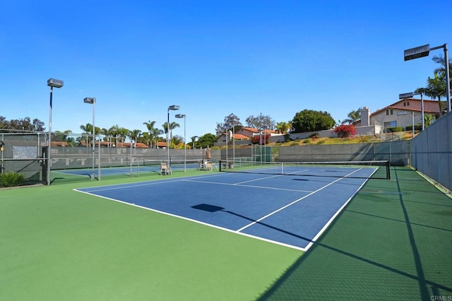 view of sport court featuring fence