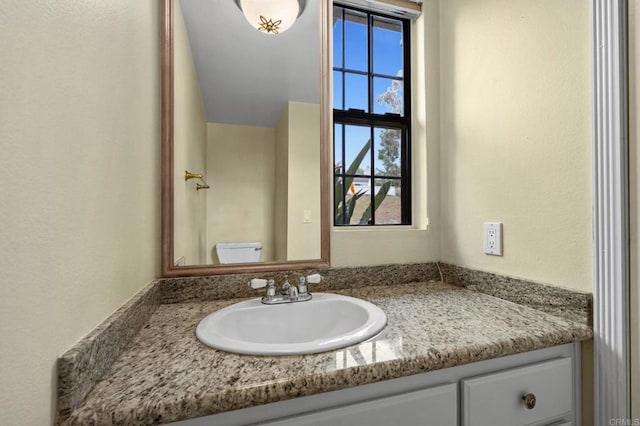 bathroom with vanity and toilet