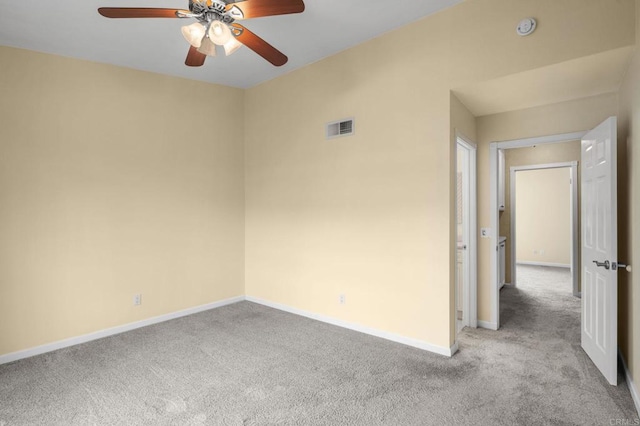 unfurnished room with baseboards, visible vents, carpet floors, and ceiling fan