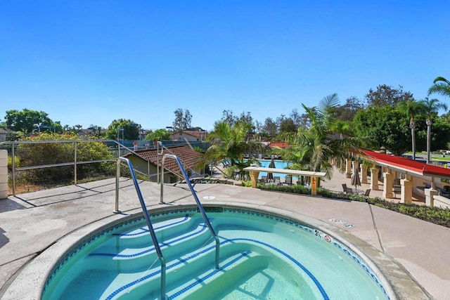 view of swimming pool featuring a community hot tub