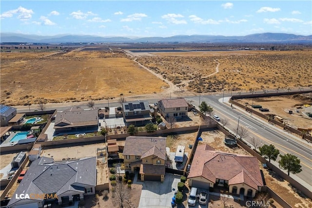 drone / aerial view with a mountain view and view of desert