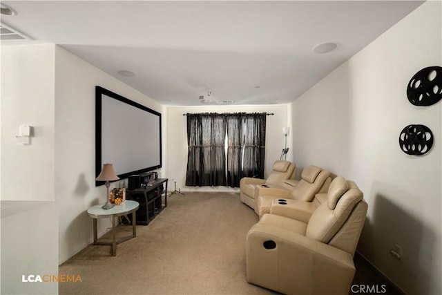 carpeted home theater room featuring visible vents