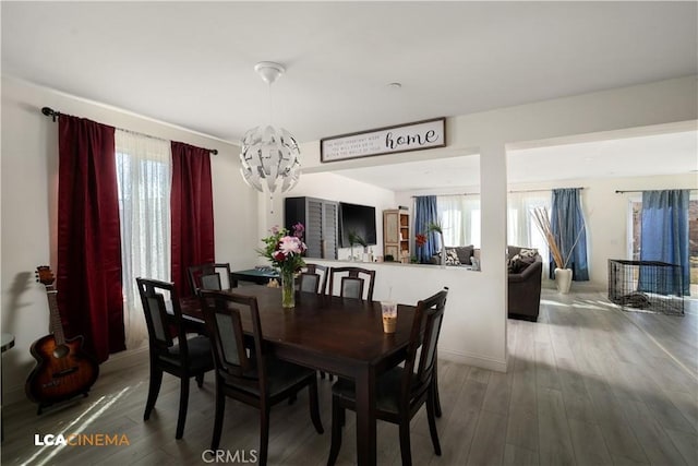 dining room with a notable chandelier and wood finished floors