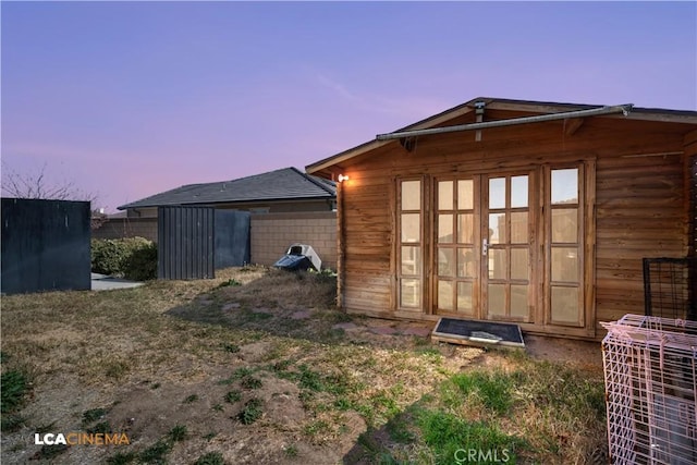 view of outbuilding with fence