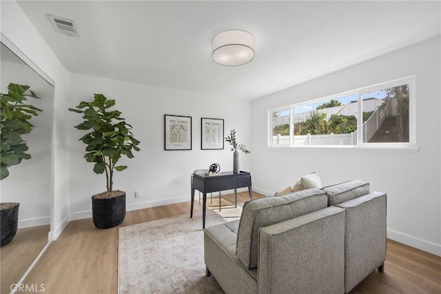 interior space with visible vents, baseboards, and wood finished floors