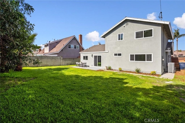 rear view of property with a yard, a patio, stucco siding, fence, and cooling unit