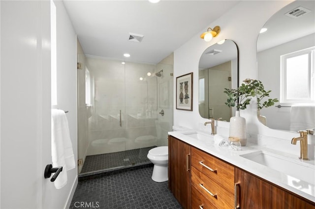 full bath featuring double vanity, visible vents, toilet, and a sink