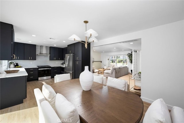 dining space featuring light wood-style floors and recessed lighting