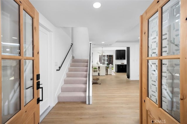 entryway featuring stairs, light wood finished floors, and recessed lighting