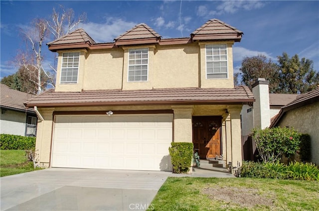 traditional-style home with concrete driveway, an attached garage, a tile roof, and stucco siding