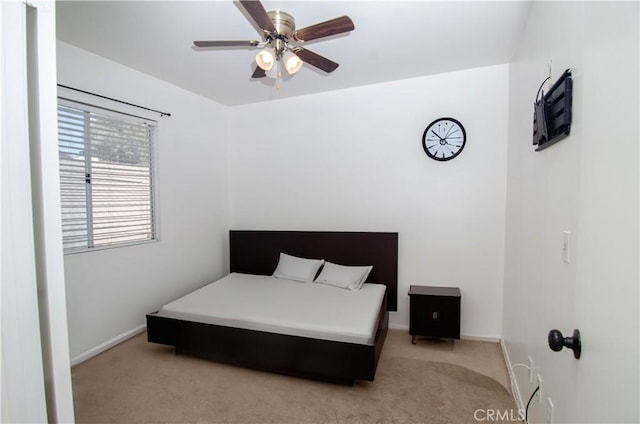 bedroom featuring baseboards and light colored carpet