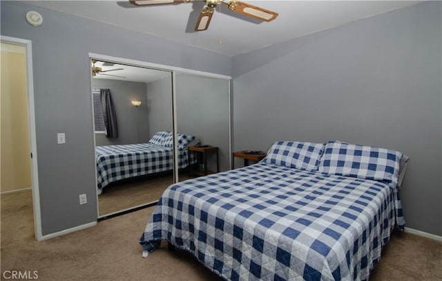 bedroom with a ceiling fan, carpet, baseboards, and a closet