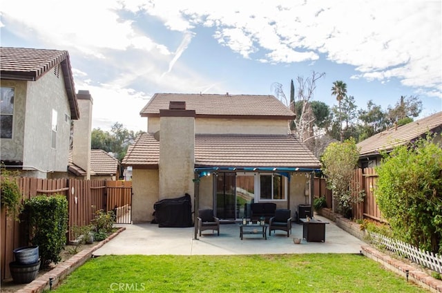 rear view of house with a fenced backyard, a patio, and a lawn