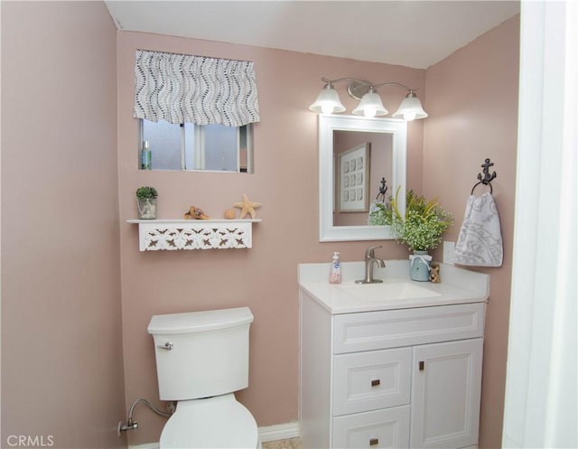 half bath featuring toilet and vanity