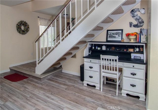 stairs with baseboards and wood finished floors