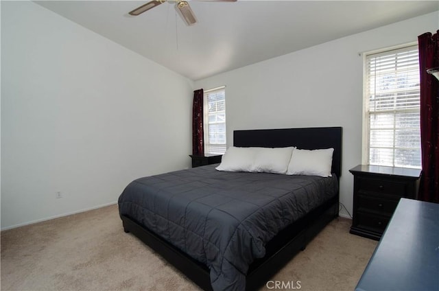 bedroom with lofted ceiling, light carpet, and ceiling fan