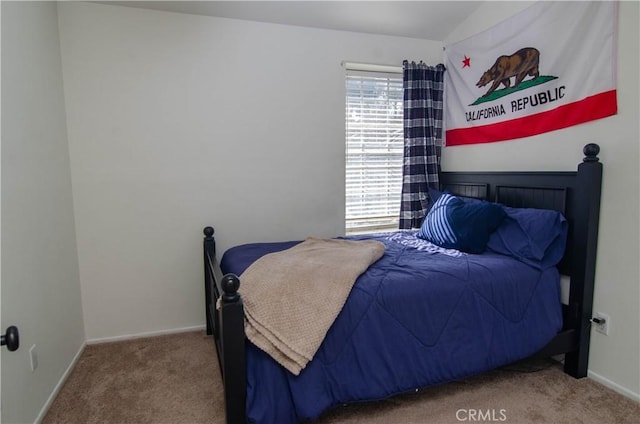 bedroom featuring carpet flooring and baseboards