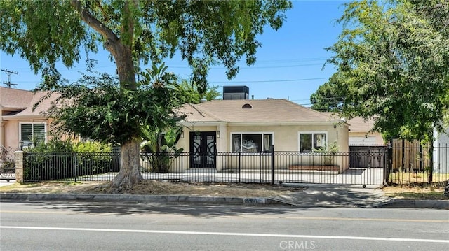 view of front facade featuring a fenced front yard and stucco siding