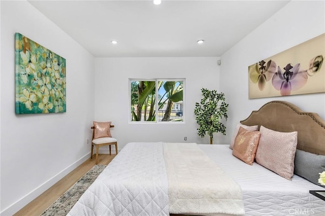bedroom with recessed lighting, baseboards, and wood finished floors