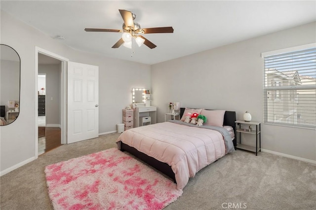 carpeted bedroom featuring a ceiling fan and baseboards