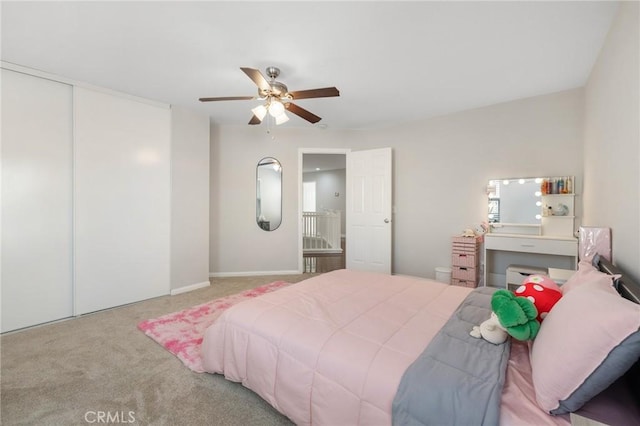 bedroom featuring carpet floors, a closet, and a ceiling fan