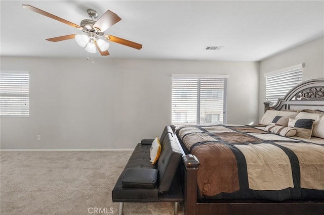 bedroom with baseboards, visible vents, ceiling fan, and carpet flooring