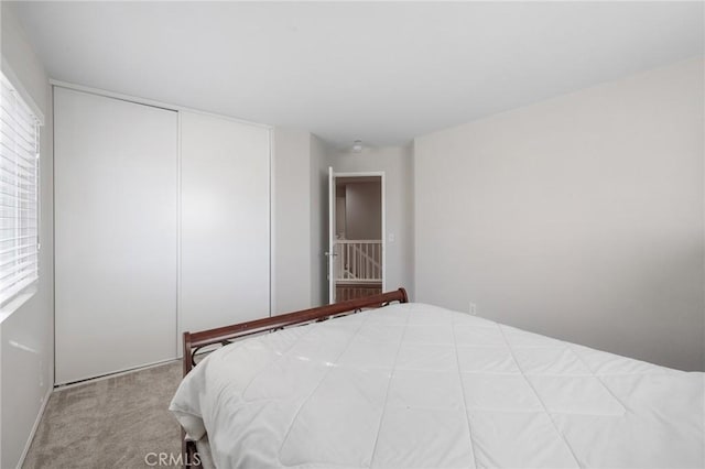 carpeted bedroom with a closet