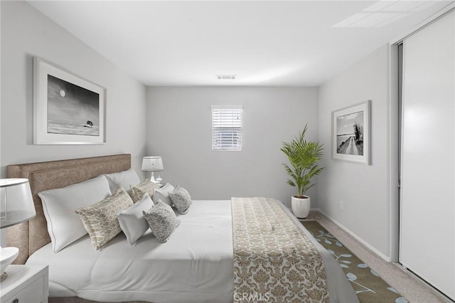 carpeted bedroom featuring visible vents and baseboards