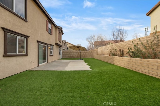 view of yard featuring a patio area and a fenced backyard