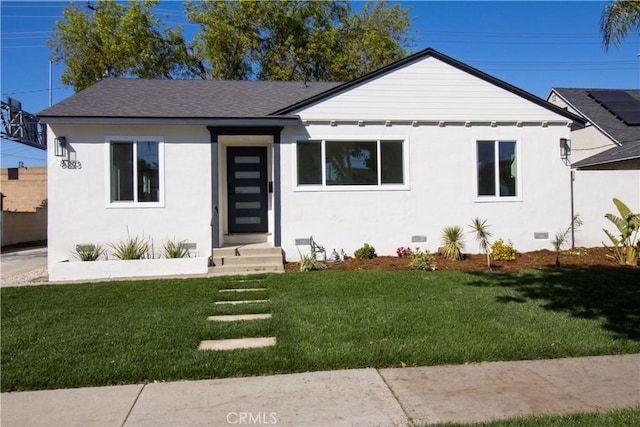 view of front of property with a front lawn, crawl space, a shingled roof, and stucco siding