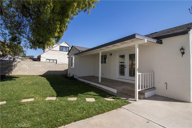 view of yard with french doors, a patio, and fence