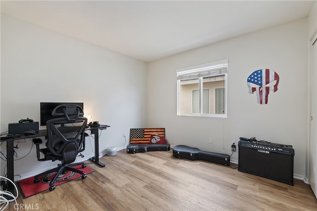 office with baseboards and wood finished floors