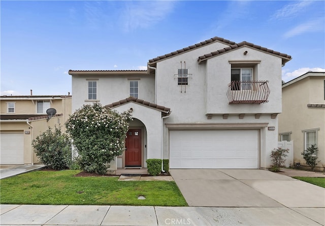 mediterranean / spanish home with a tiled roof, a balcony, a garage, and stucco siding