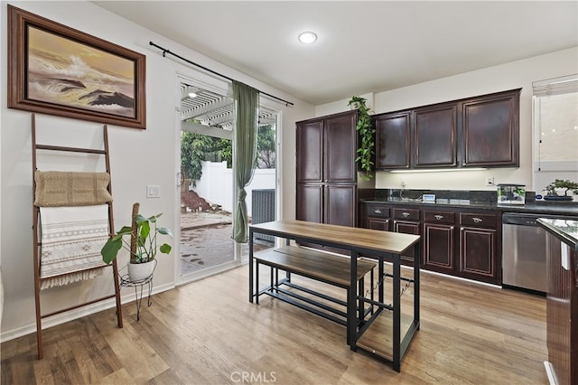 kitchen featuring baseboards, stainless steel dishwasher, dark brown cabinets, and light wood-style flooring